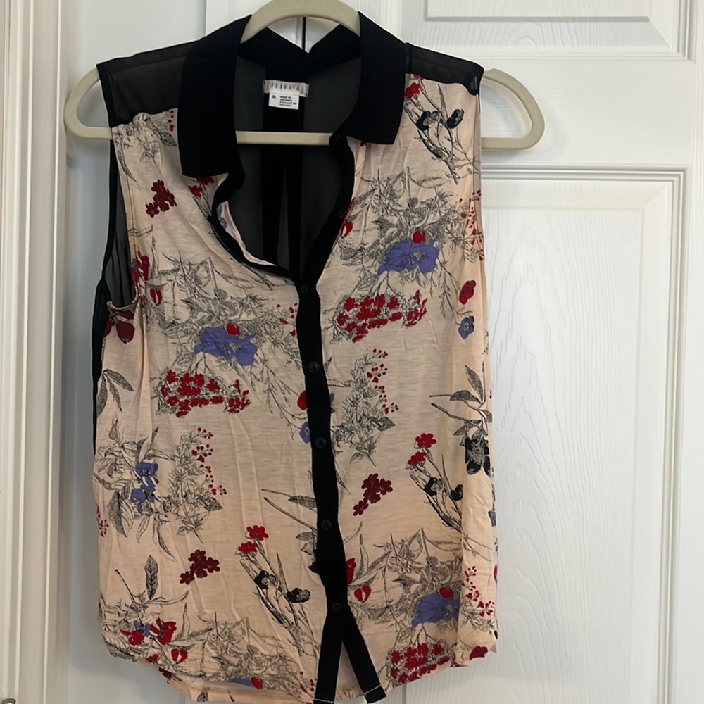Sleeveless floral print top with partially black sheer back
